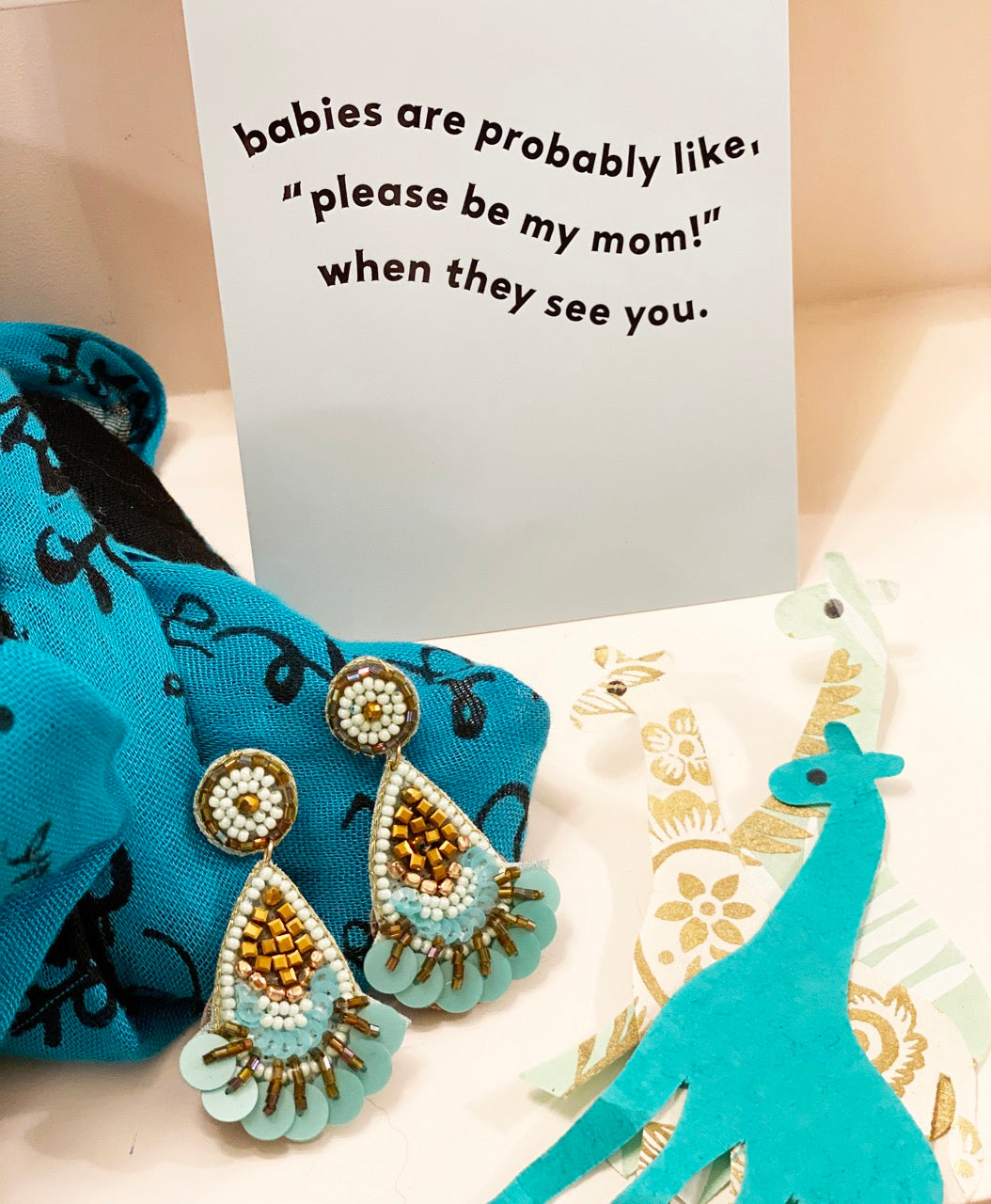 Unique aqua earrings featuring a raindrop shape and double waffle design, perfect for adding a pop of color.