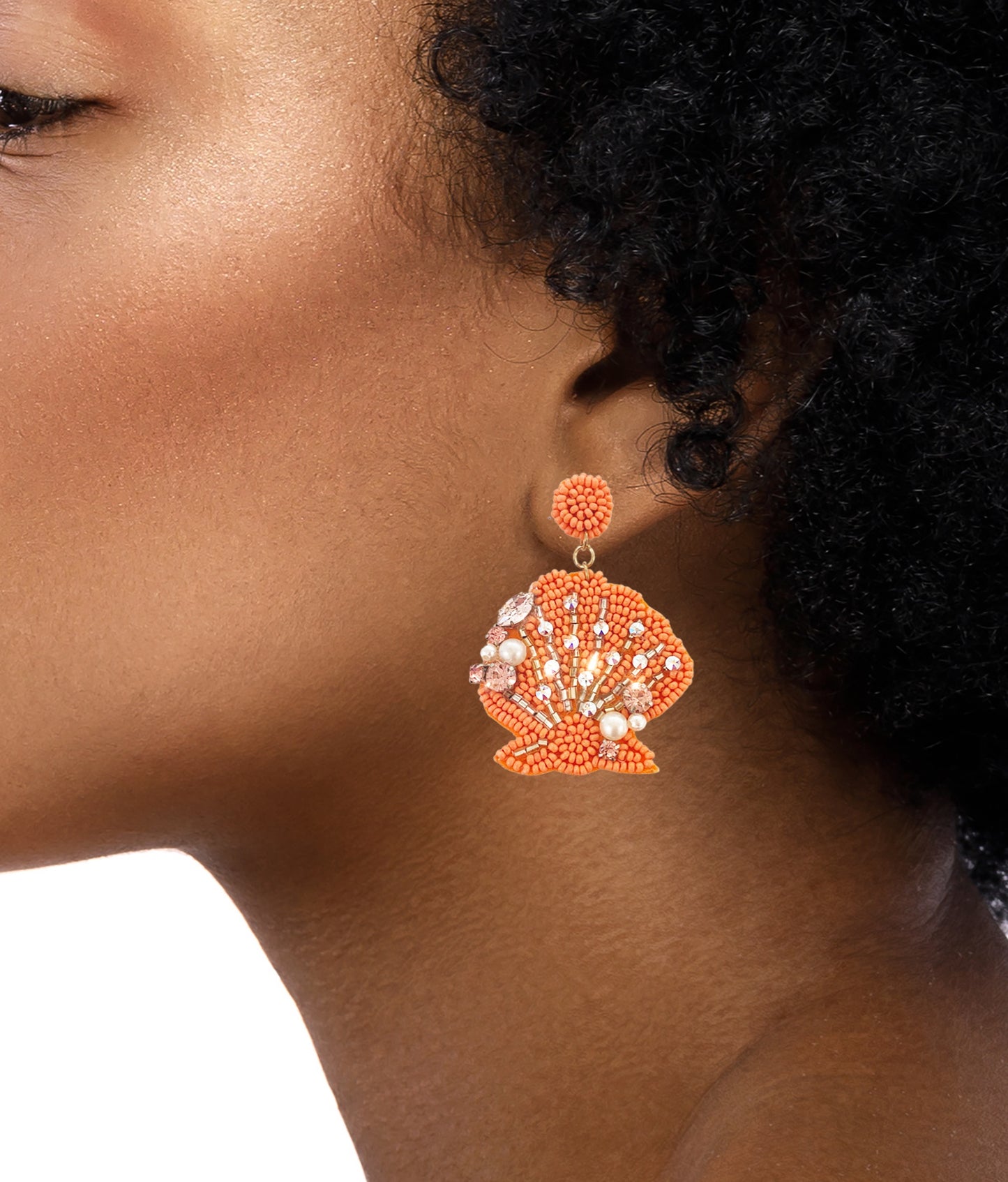 Unique beaded earrings with coral and seashell design, perfect for a beach getaway.