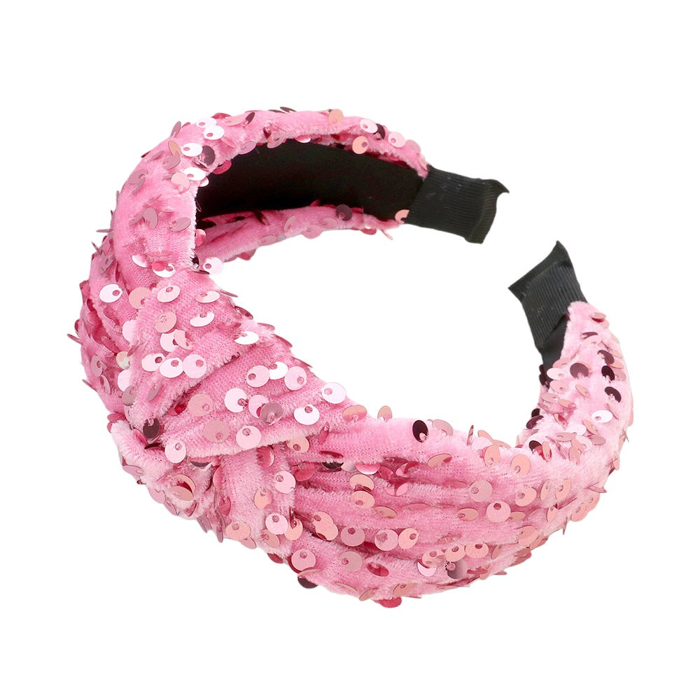 Sparkly pink velvet headband with sequin details, ideal for adding a touch of glamour to any outfit.