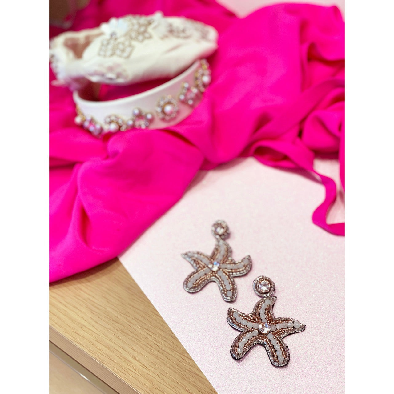 Unique starfish earrings featuring a beaded design and playful patches, perfect for a chic coastal style.