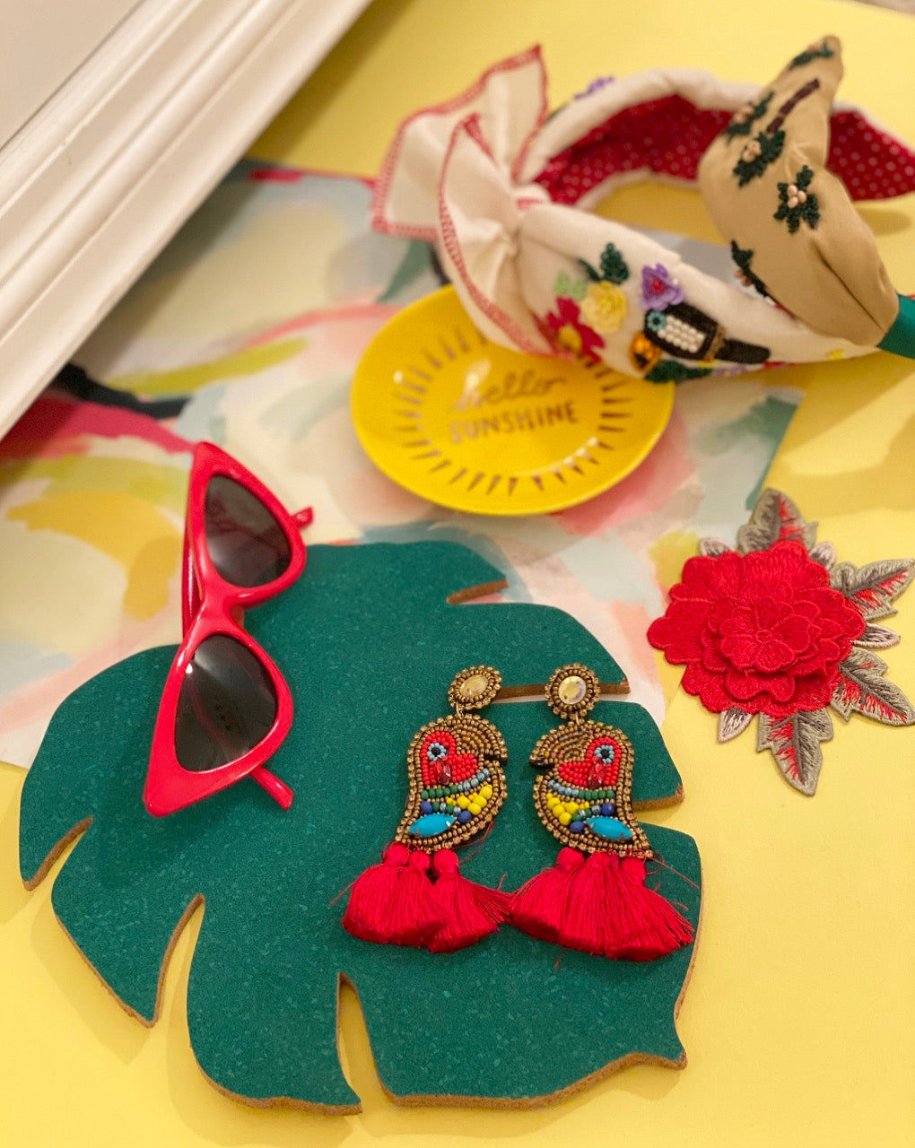 Tropical bird earrings with red tassels and boombox details, perfect for adding color to any outfit.
