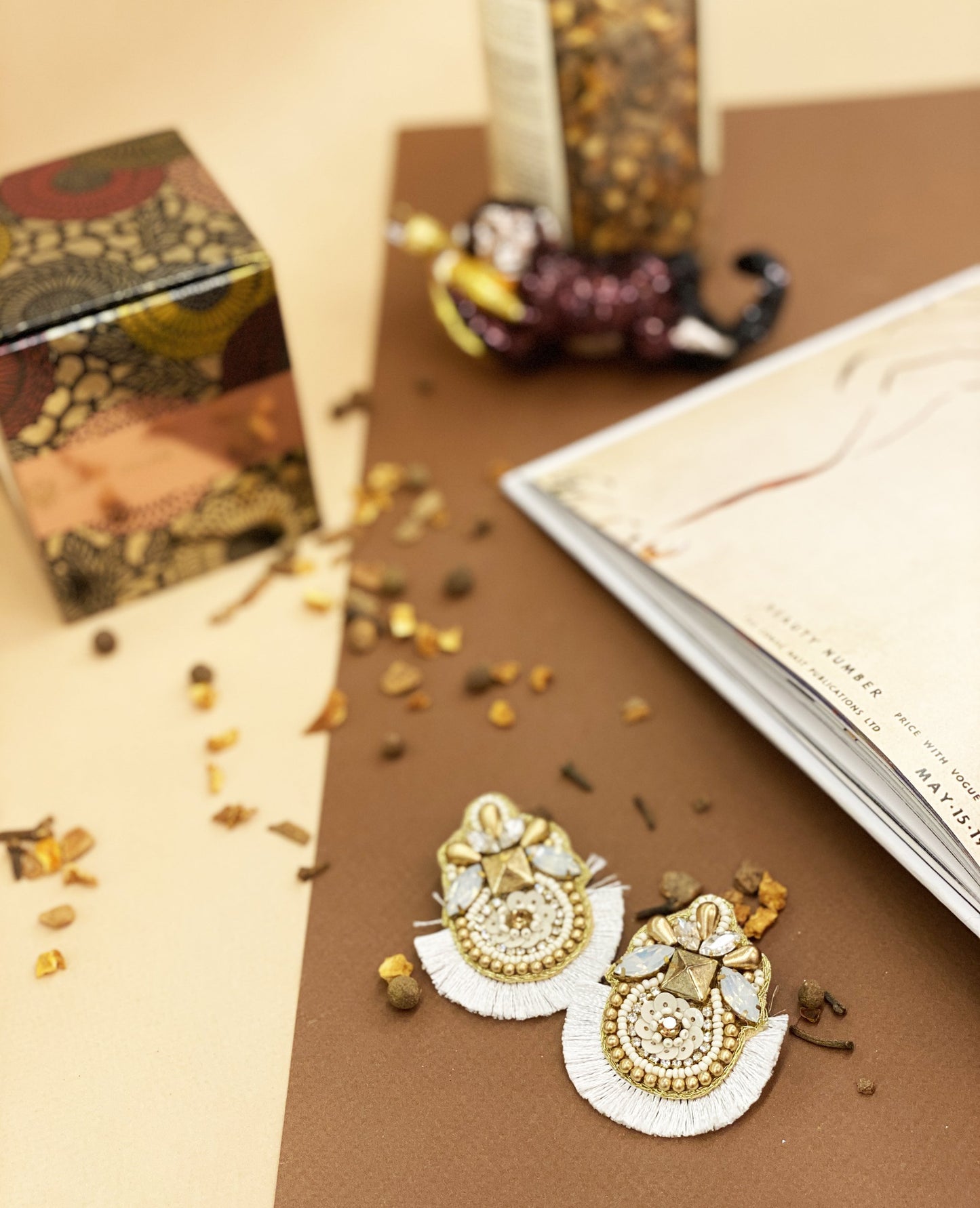 Stylish and lightweight Sun Saint Earrings with a sizzling sun design, cool saint patches, and playful artistic details.