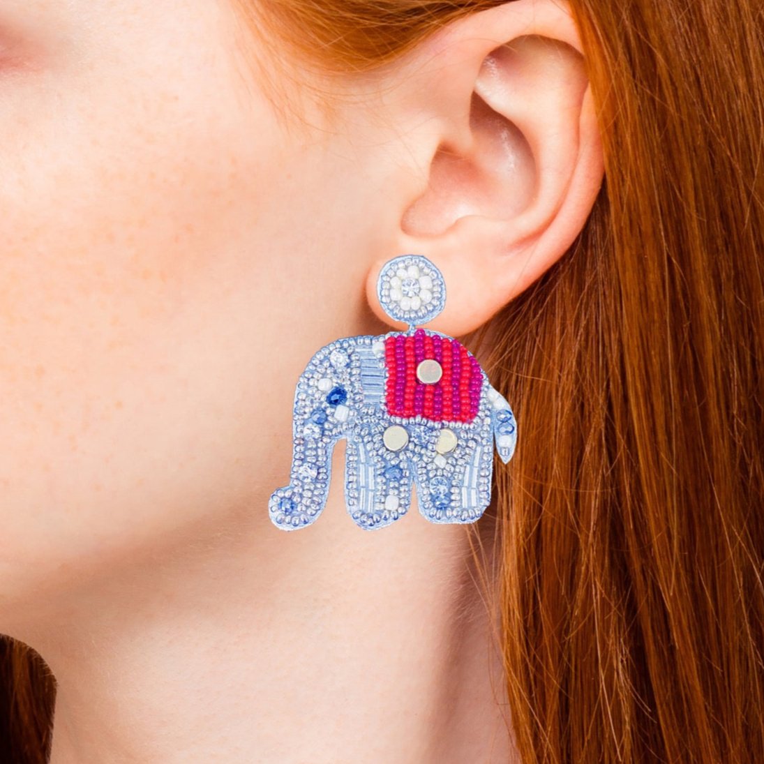 Charming and intricate elephant-shaped earrings with dazzling blue and silver beadwork, accented by vibrant red details—perfect for adding a touch of playful elegance to your look.