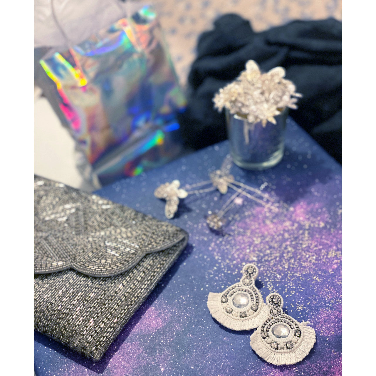 Statement white earrings with rhinestones and pearls, offering a unique design.