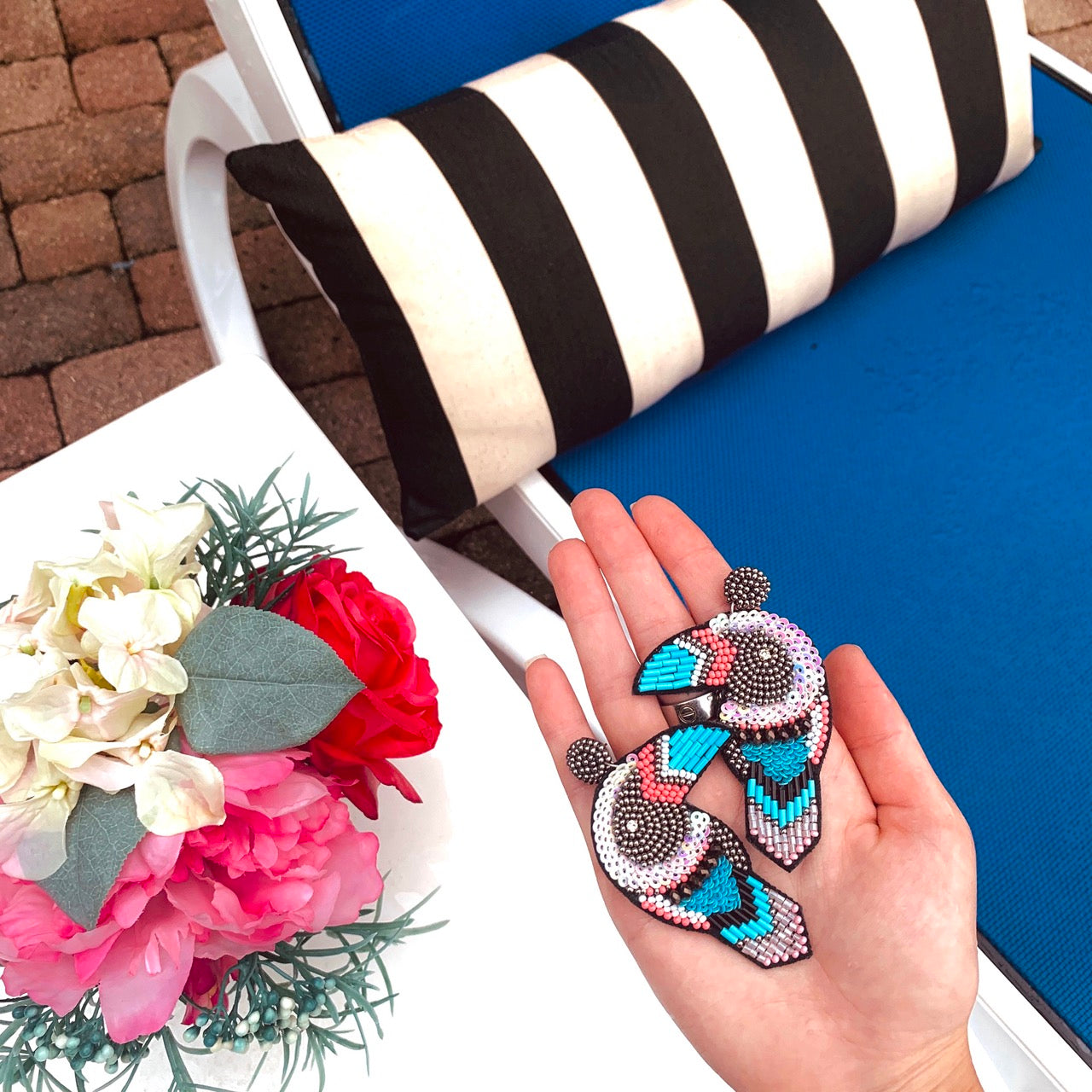 Whimsical toucan earrings with jungle-inspired colors and embroidered felt detailing