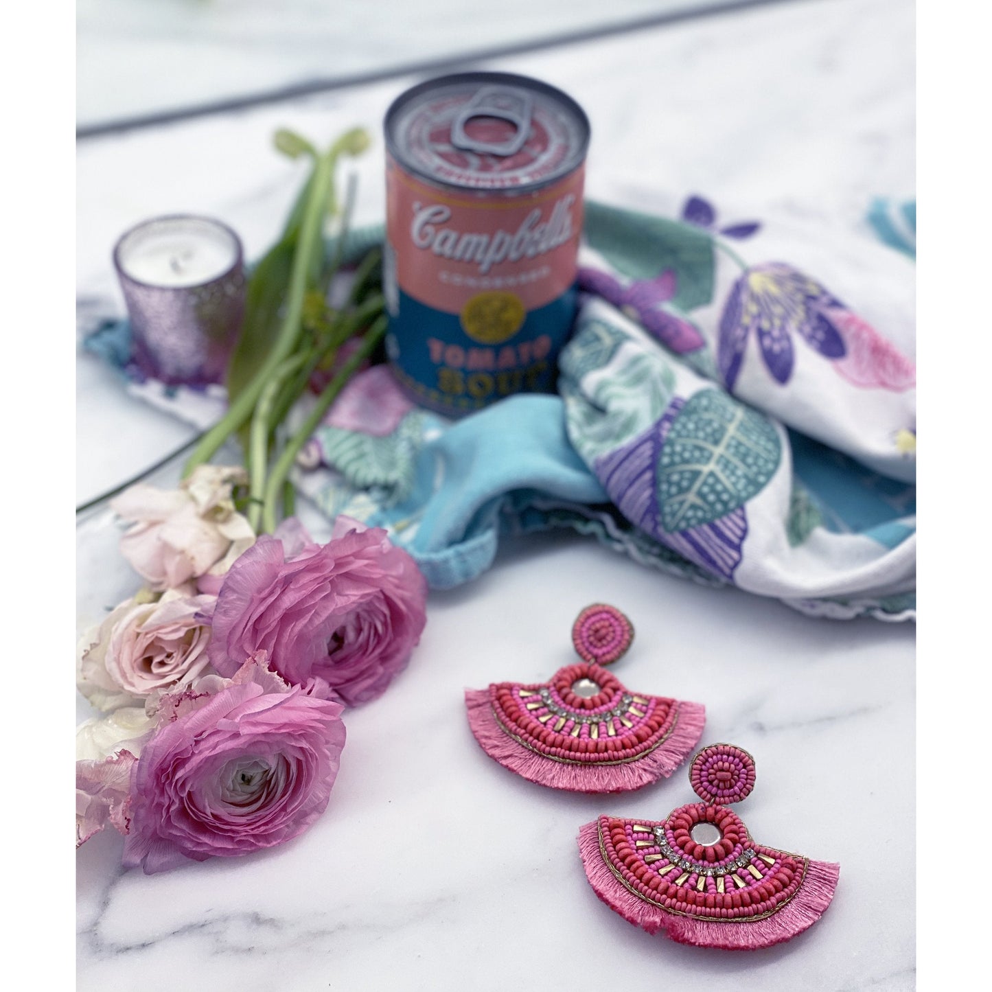 Oversized pink fringe earrings featuring graphic "chill AF" embroidery and beaded detailing