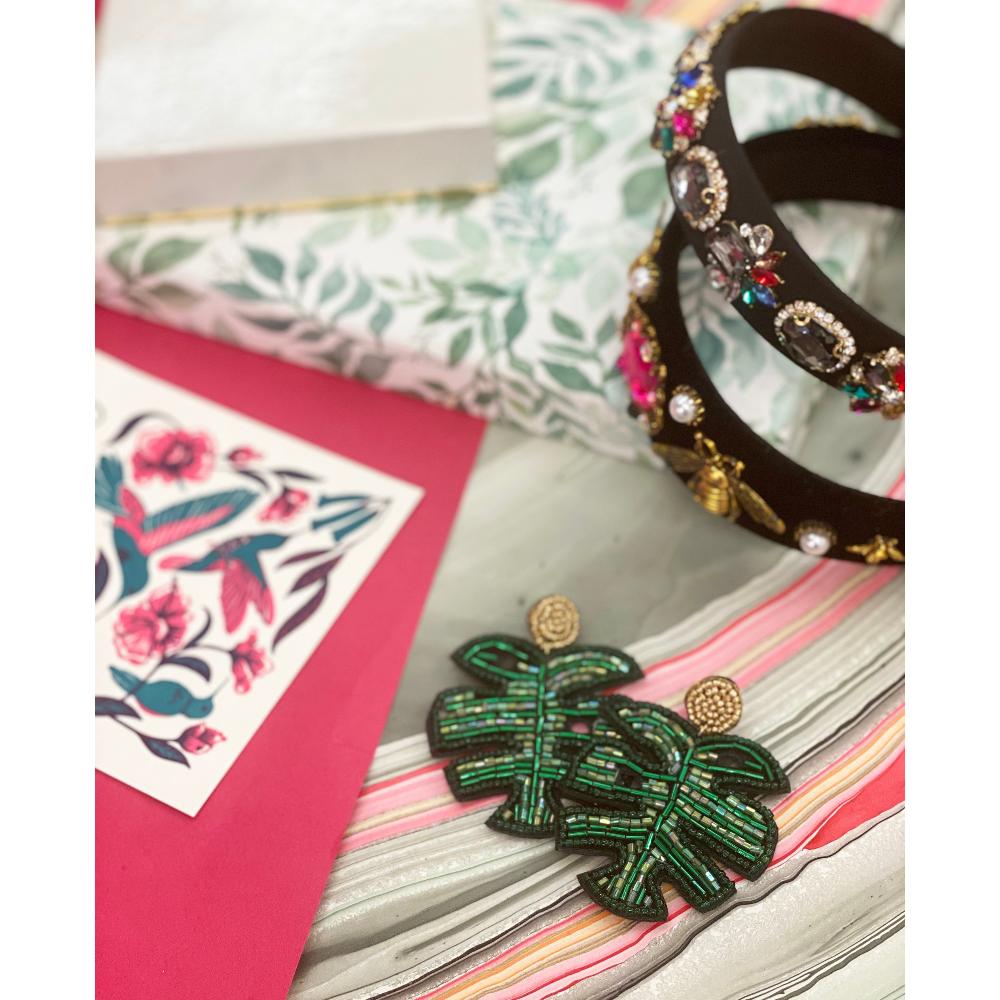 Stylish tropical leaf earrings, featuring detailed green beadwork and a hypoallergenic design, inspired by Fiji's natural beauty.