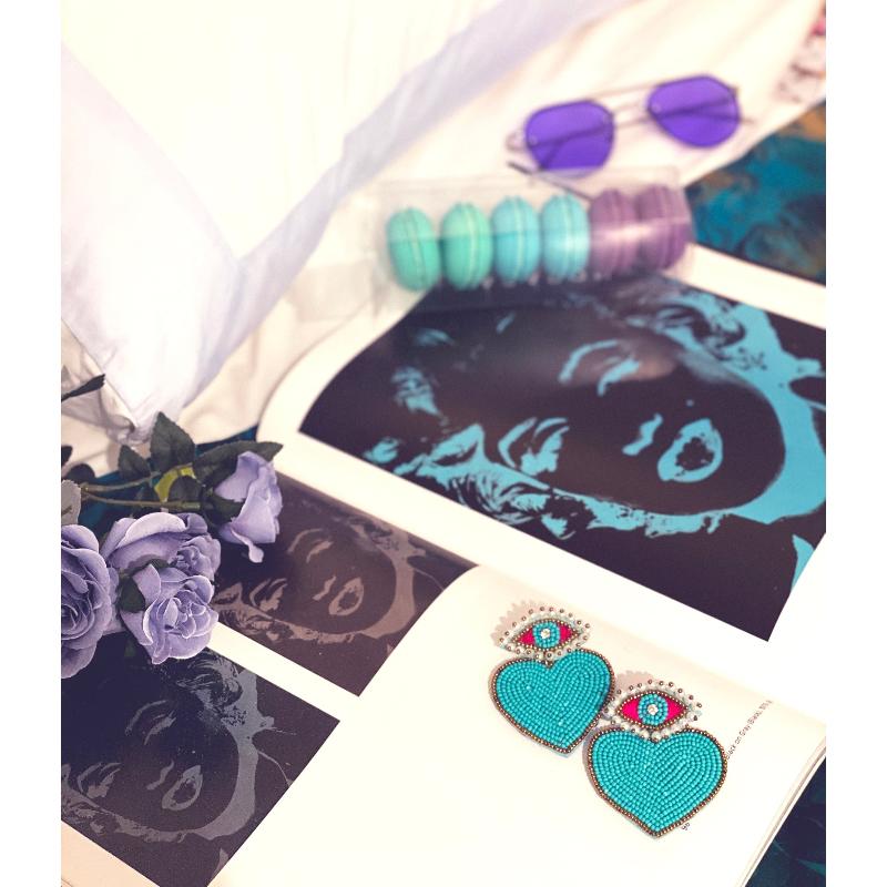 Fashionable beaded earrings with playful patch motifs, perfect for expressing personality and making a statement.