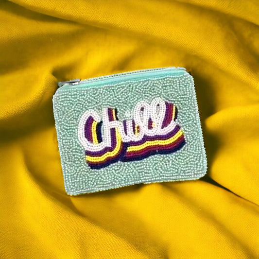 Chic beaded pouch crafted from soft velvet and adorned with an array of colorful beads in geometric patterns, perfect for storing small essentials in style.
