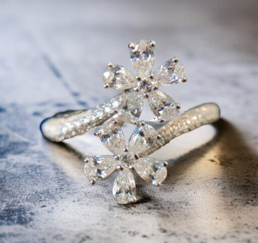 Elegant silver floral ring with sparkling stones.