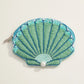Mint and teal beaded clam shell pouch with zipper and pearl accent on a white background