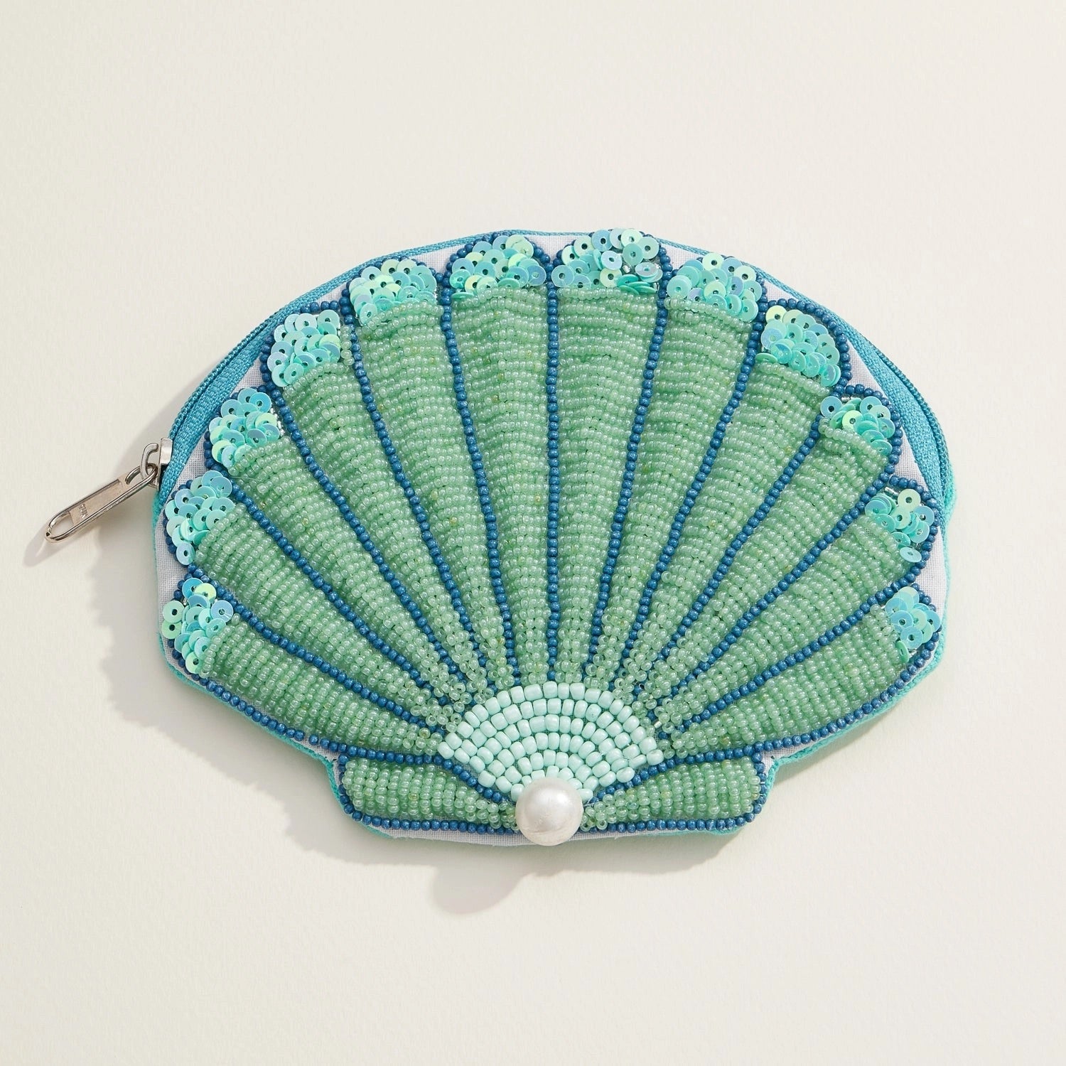 Mint and teal beaded clam shell pouch with zipper and pearl accent on a white background
