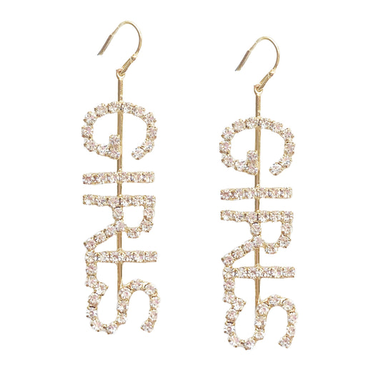 Gold-tone earrings spelling GIRLS in rhinestones for bold statement style
