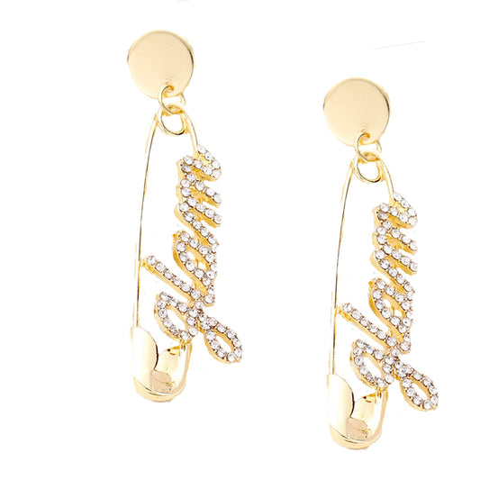 Gold safety pin earrings with crystal-encrusted “GLAM” lettering for statement style