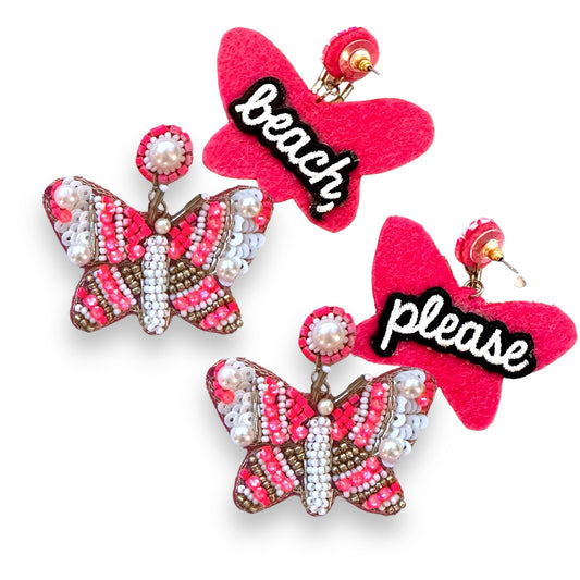 Intricate fuchsia butterfly earrings suspended from elegant chains provide a statement-making accessory for special occasions.