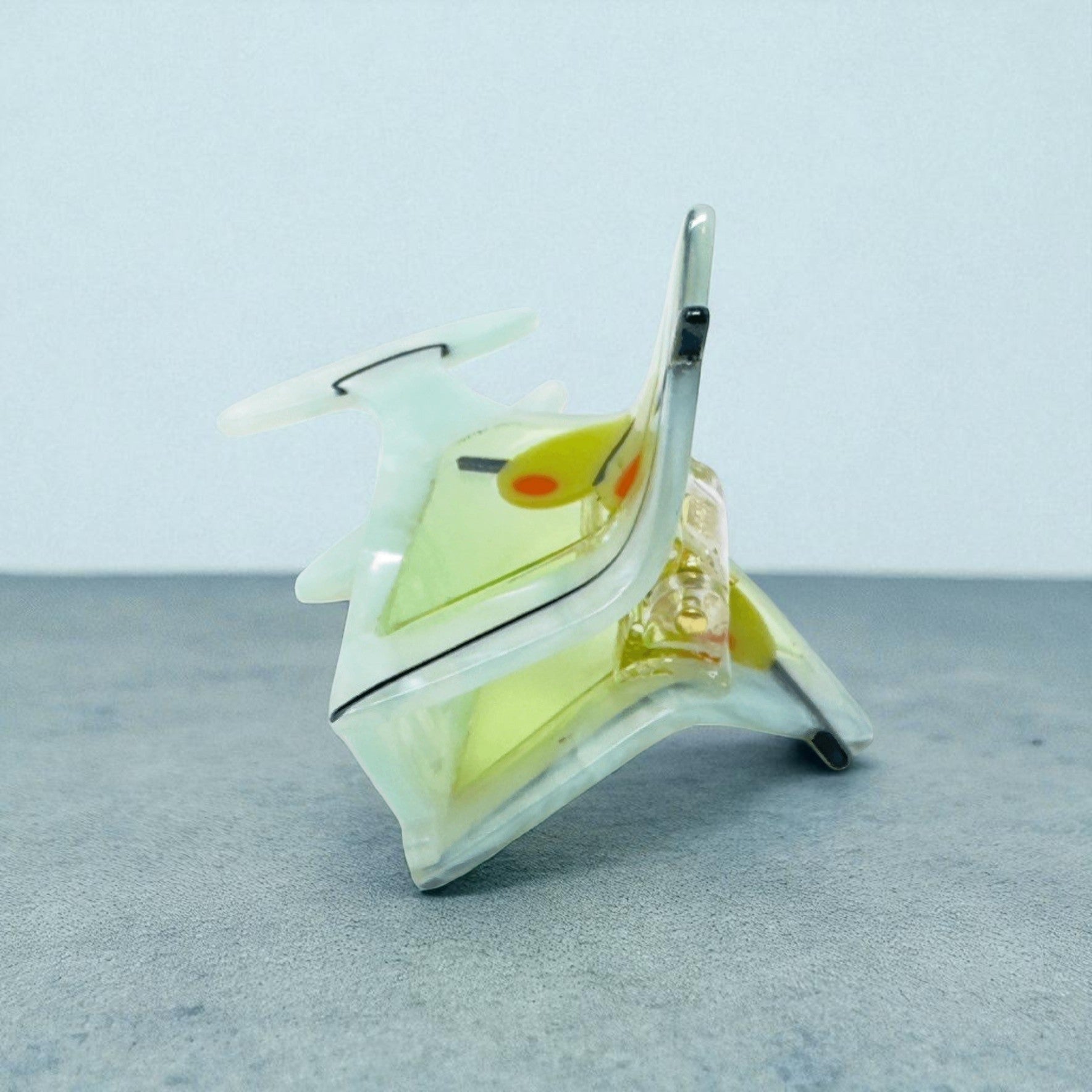 Back view of a martini glass hair clip featuring olives and pearlescent acrylic.