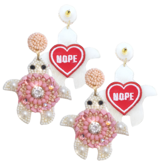 Pink Turtle Earrings featuring playful turtle design with pink beading and a cheeky "Nope" patch, perfect for a fun look.