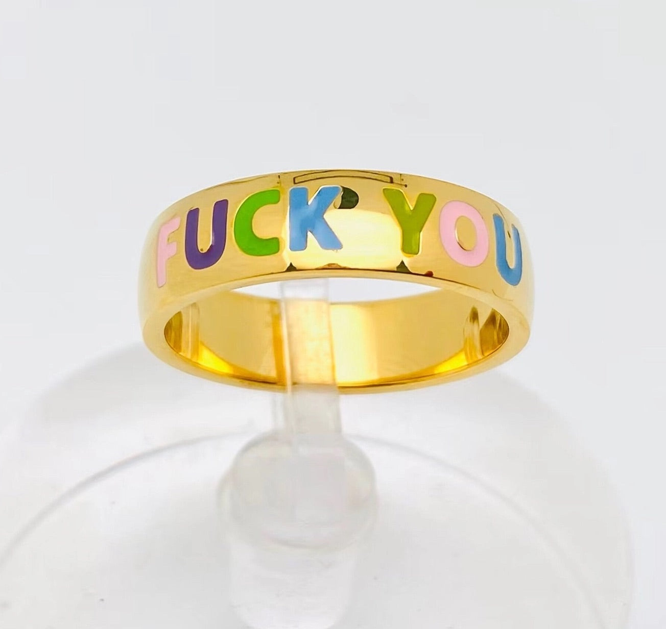 Gold statement ring with colorful rainbow enamel letters spelling "FUCK YOU", bold and edgy jewelry design