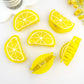 Multiple lemon slice hair clips arranged in a flatlay pattern — juicy, bold, and summery.