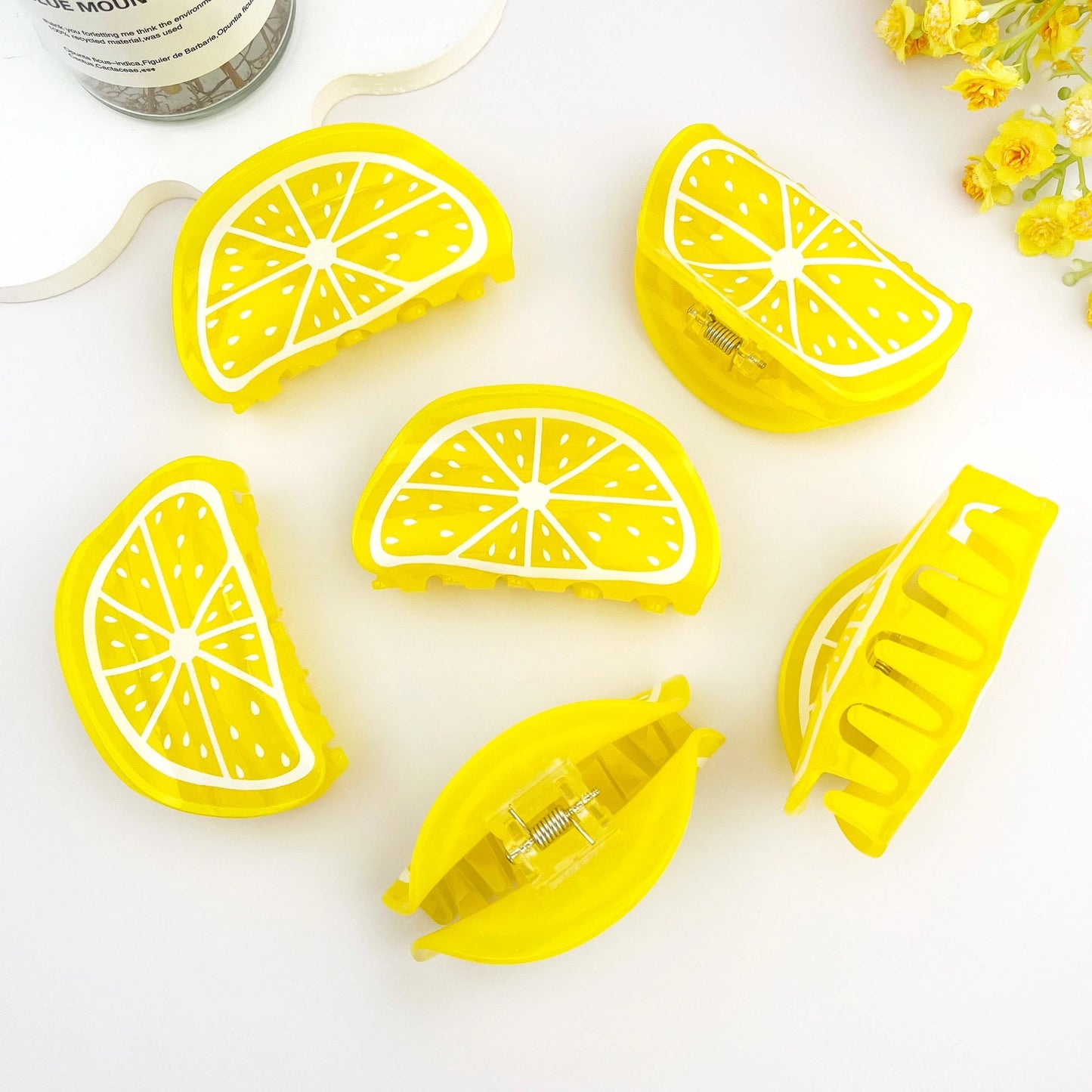 Multiple lemon slice hair clips arranged in a flatlay pattern — juicy, bold, and summery.