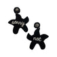 Handcrafted starfish earrings with intricate beading and "Not Sorry" detail, perfect for beach lovers.